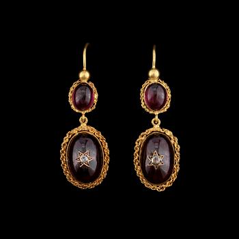 1068. Cabochon cut earrings with garnets and old-cut diamonds.