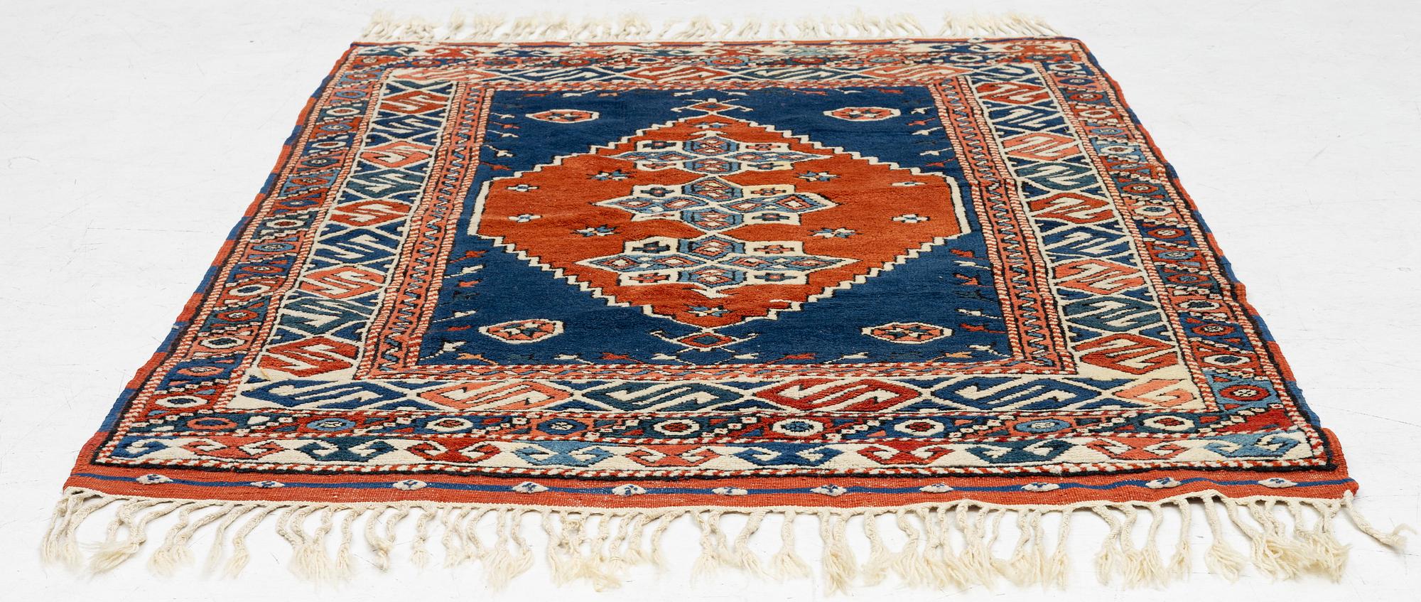 A semi-antique Turkish rug, 175 x 123 cm.