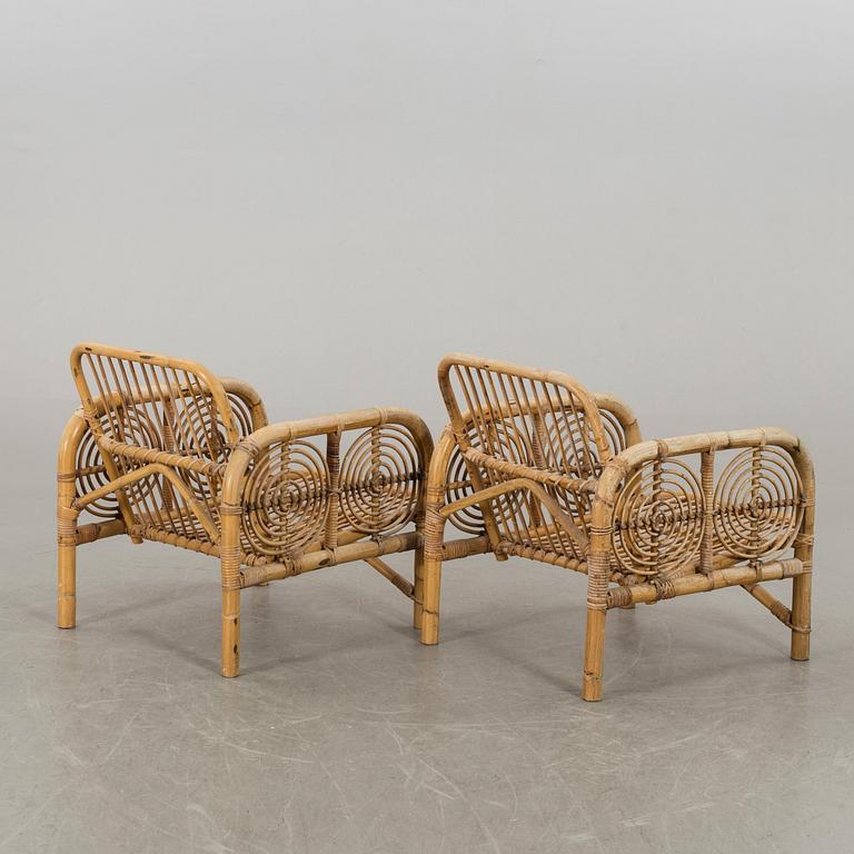 A pair of the second half of the 20th century ratten and bamboo lounge chairs.