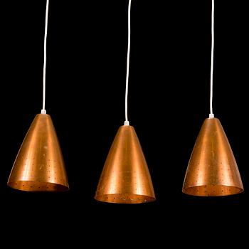 A 1960s three-shade copper and wood pendant ceiling light.