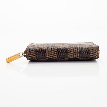 Louis Vuitton, a 'Zippy Coin Purse' wallet and an 'Inventeur' belt.