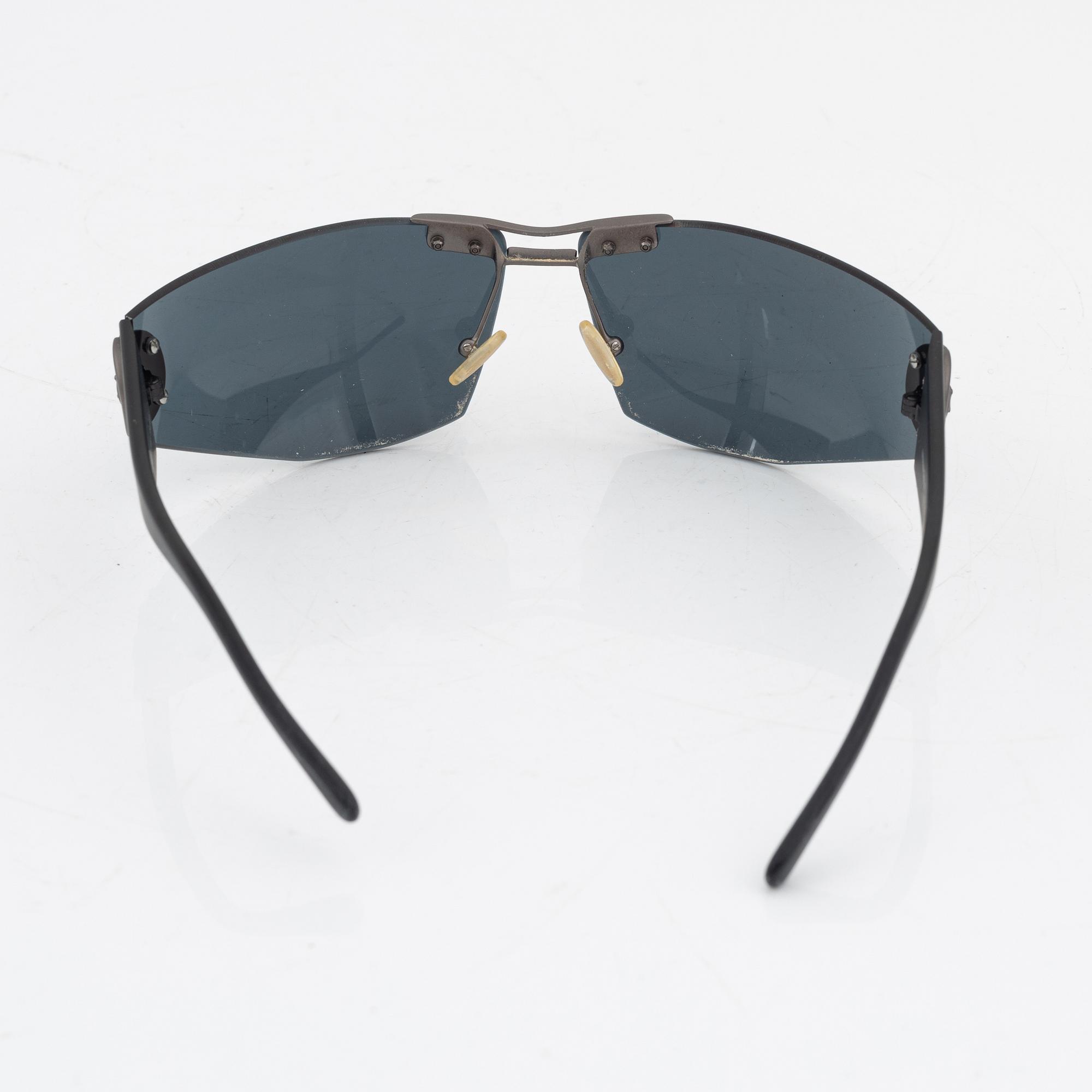 Céline, a pair of black and silver-color sunglasses.