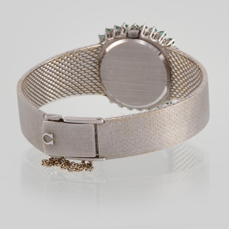 ARMBANDSUR, Omega, 18K vitguld med briljantslipade diamanter samt fasettslipade smaragder. Vikt 64,6 gram.