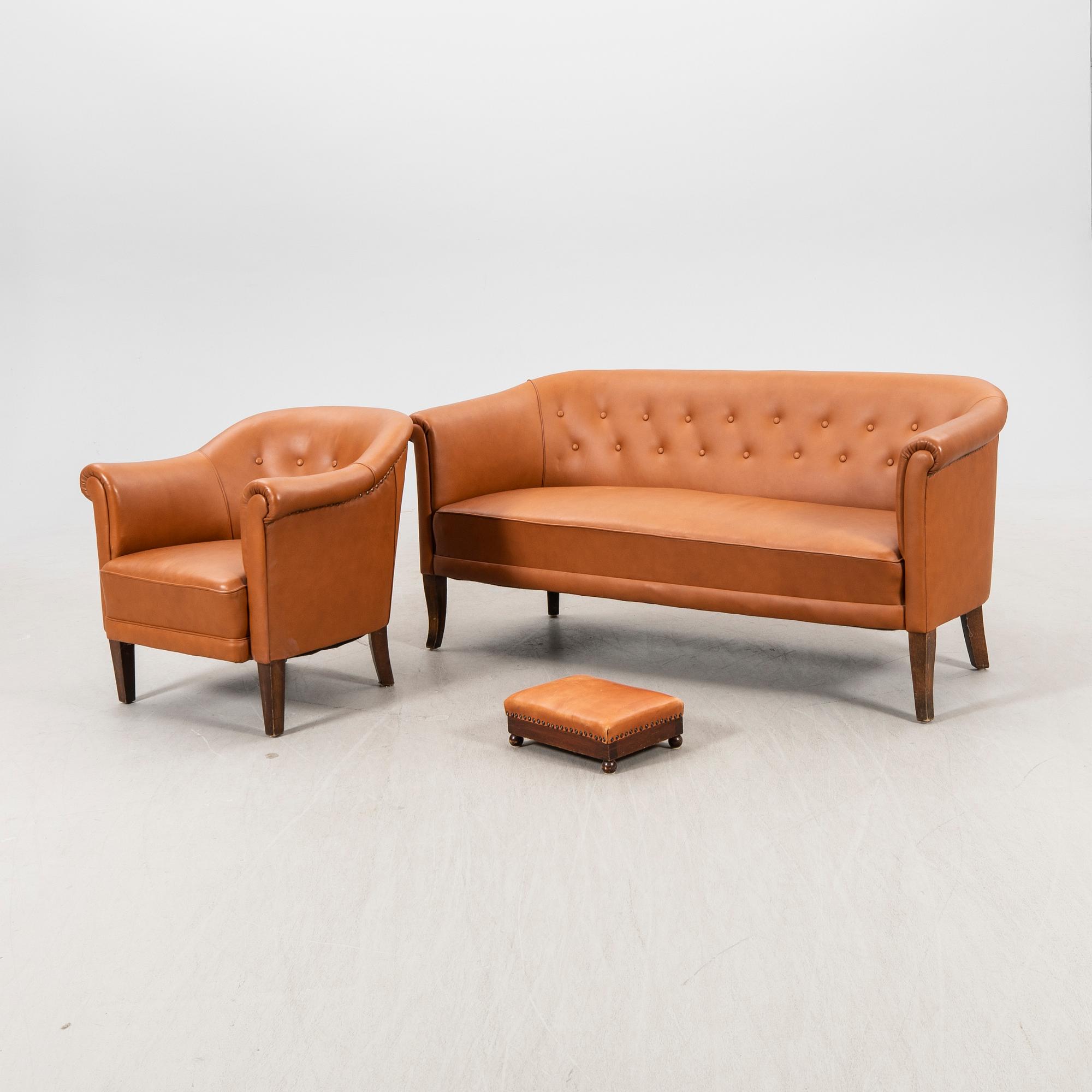 A leather sofa and armchair 1940s.