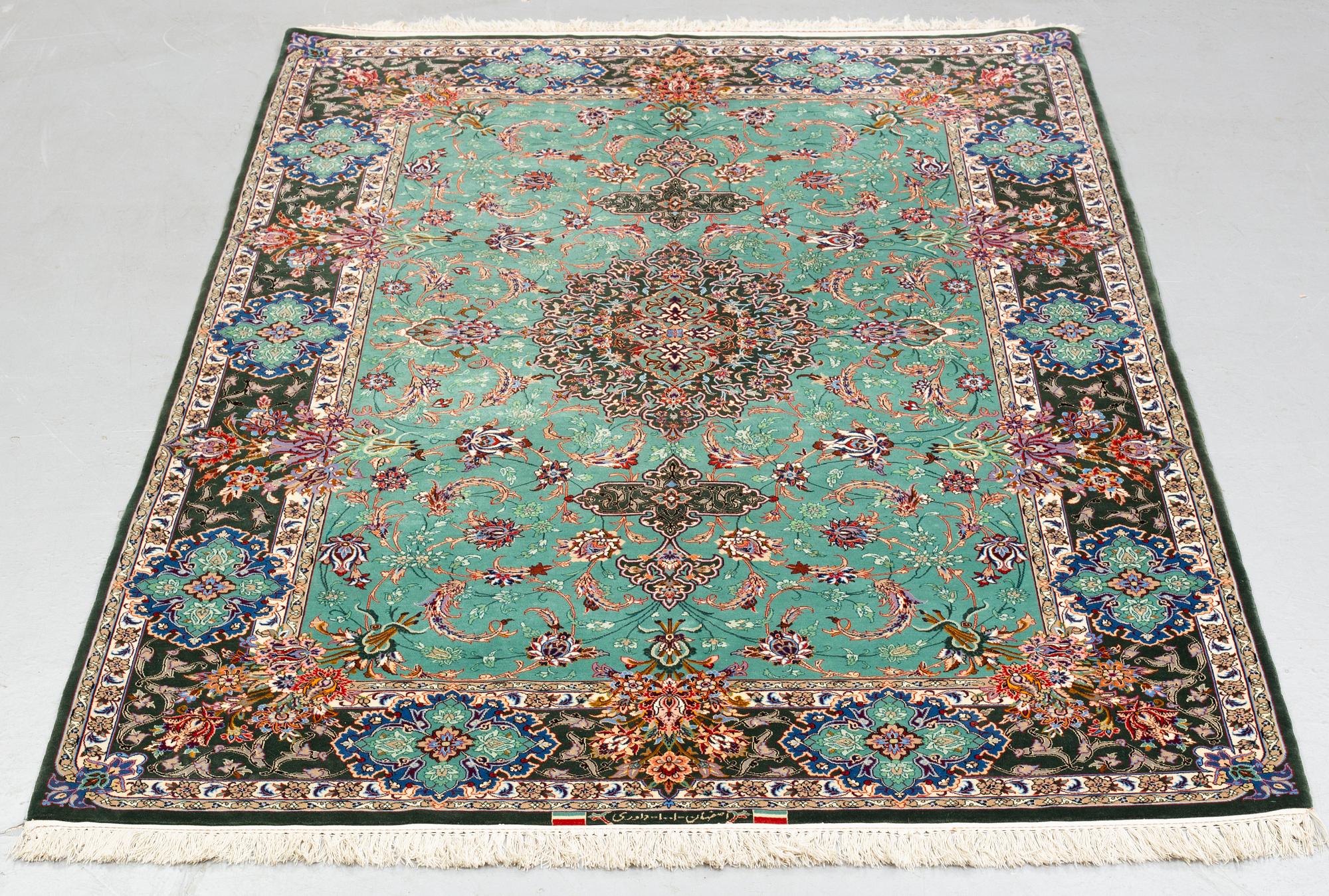 A rug, old Esfahan, part silk, signed, ca 225 x 149 cm (ca 1,5-2,5 cm flat weave at the ends).