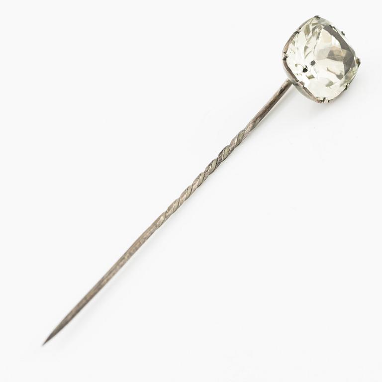A brooch, a brooch pin, and a pendant, likely 19th century.