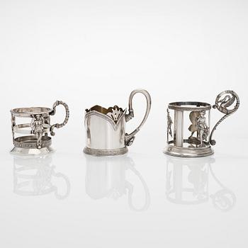 Three silver tea glass holders, 2XA-artel in St. Petersburg, and Odessa and Moscow, late 19th and early 20th centuries.