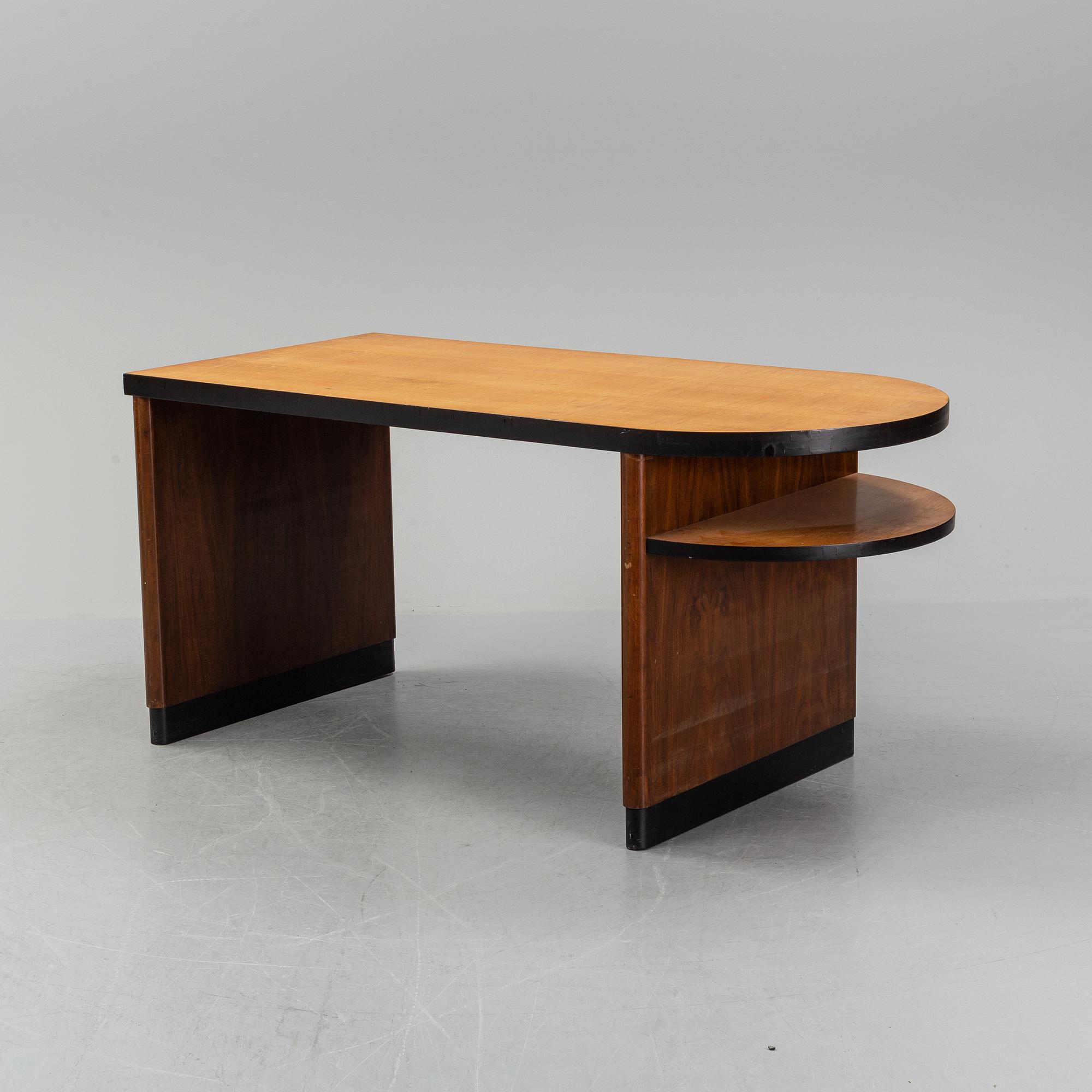Axel Einar Hjorth, attributed to. A walnut and birch desk, Nordiska Kompaniet, 1930's.