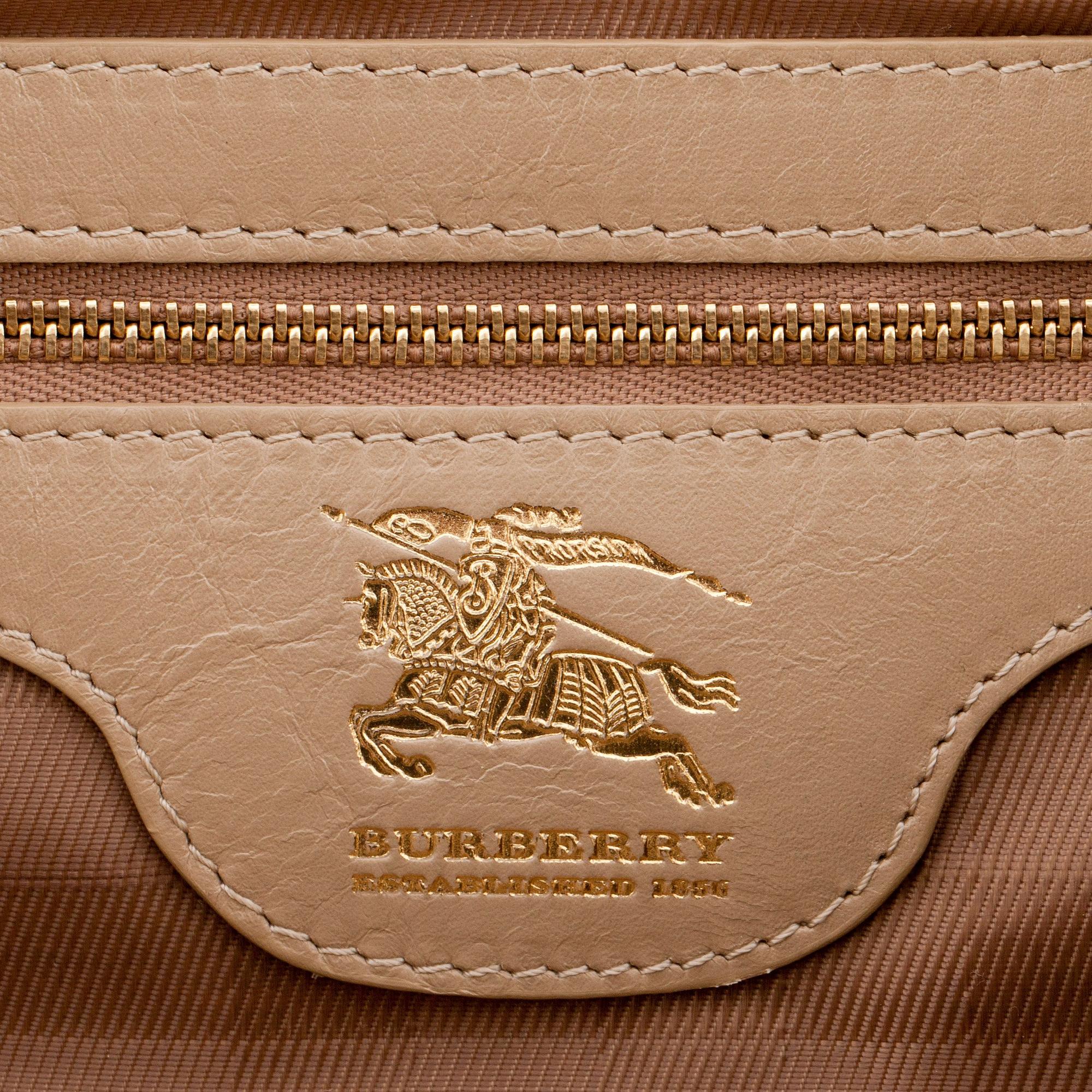BURBERRY, a beige leather weekend bag.
