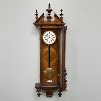 A late 19th century wall pendulum clock.
