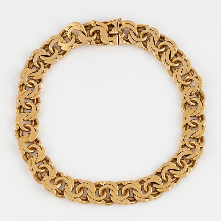 An 18K gold bracelet.