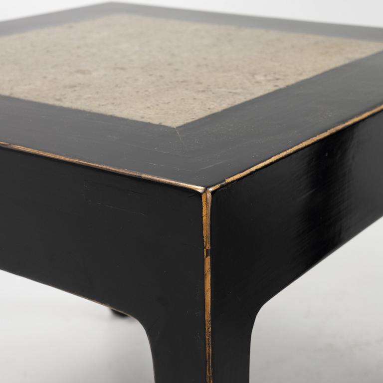 A pair of blac painted side tables with stone tops.