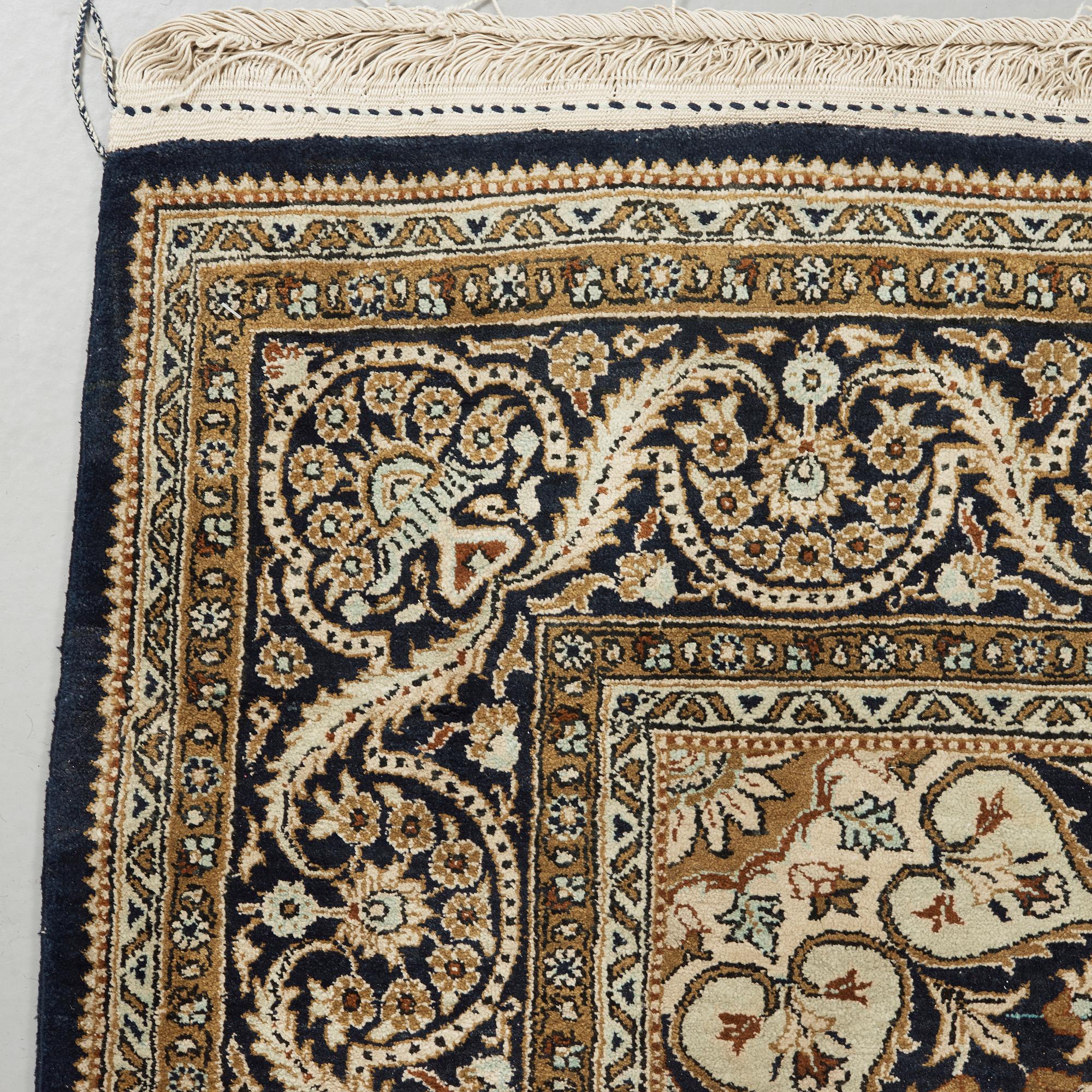 A silk Qum carpet, around  219 x 137 cm.
