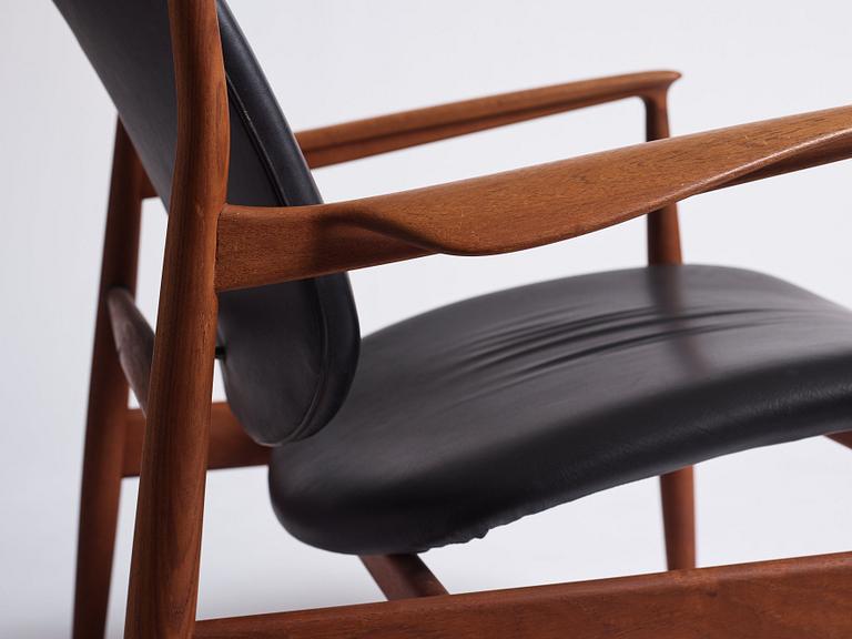 Finn Juhl, a teak and black leather 'model 136' easy chair, France & Daverkosen, Denmark 1950-60s.