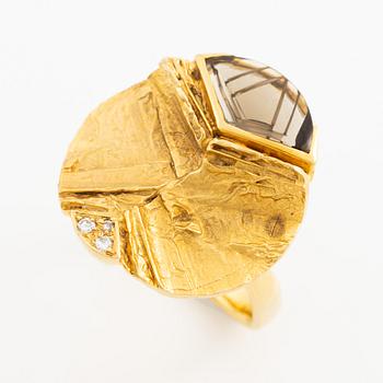 A ring, 18K gold with a fancy-cut smoky quartz and round brilliant-cut diamonds.