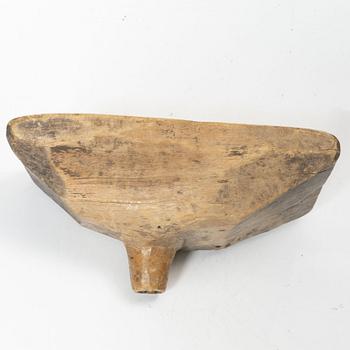 A Swedish carved wood milk funnel, dated 1687.