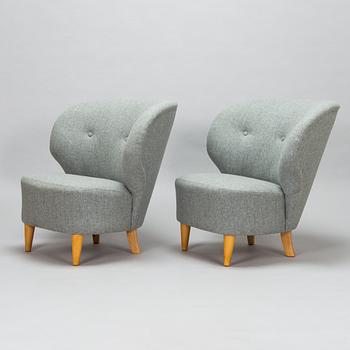 A pair of mid-20th-century armchairs.