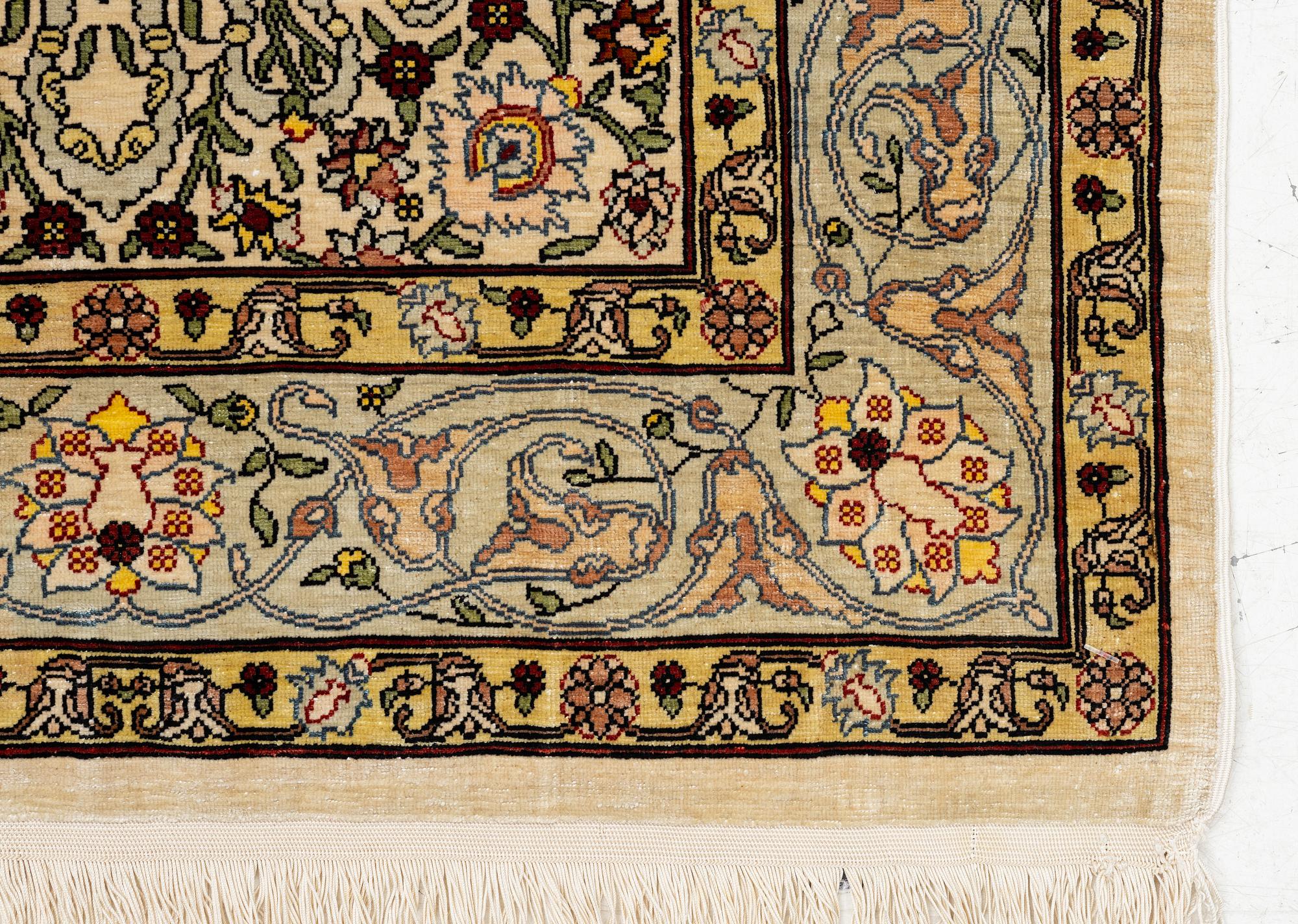 A silk Hereke rug, Turkey, approx. 82 x 58 cm.