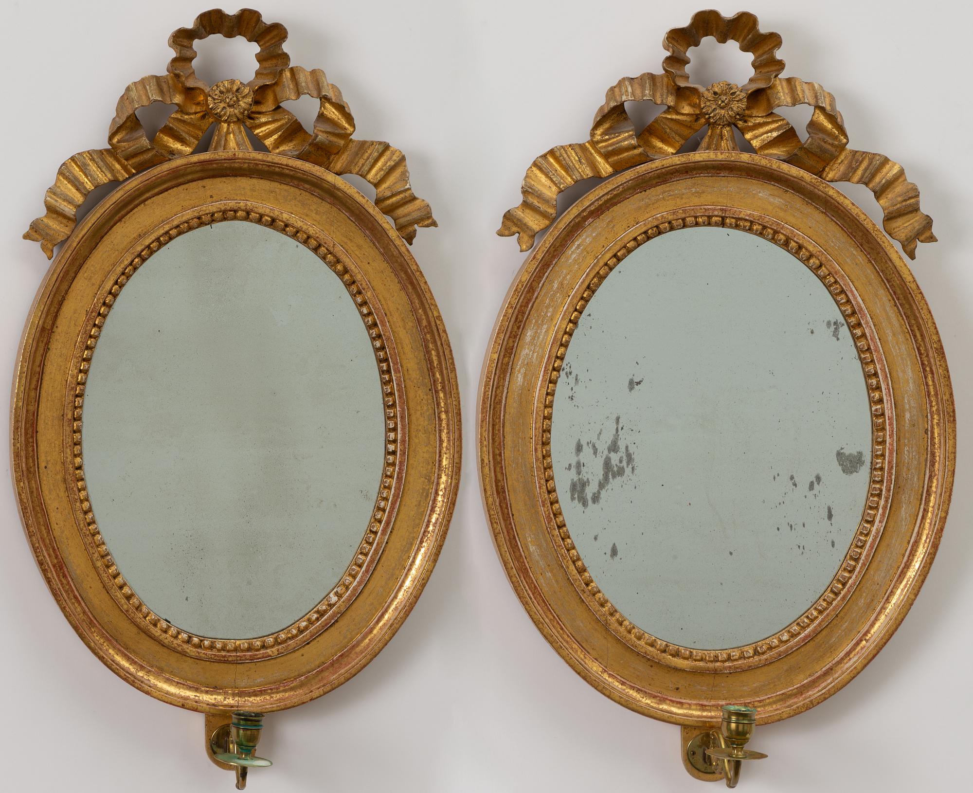 A pair of late Gustavian one-branch giltwood girandole mirrors, Stockholm, circa 1800.