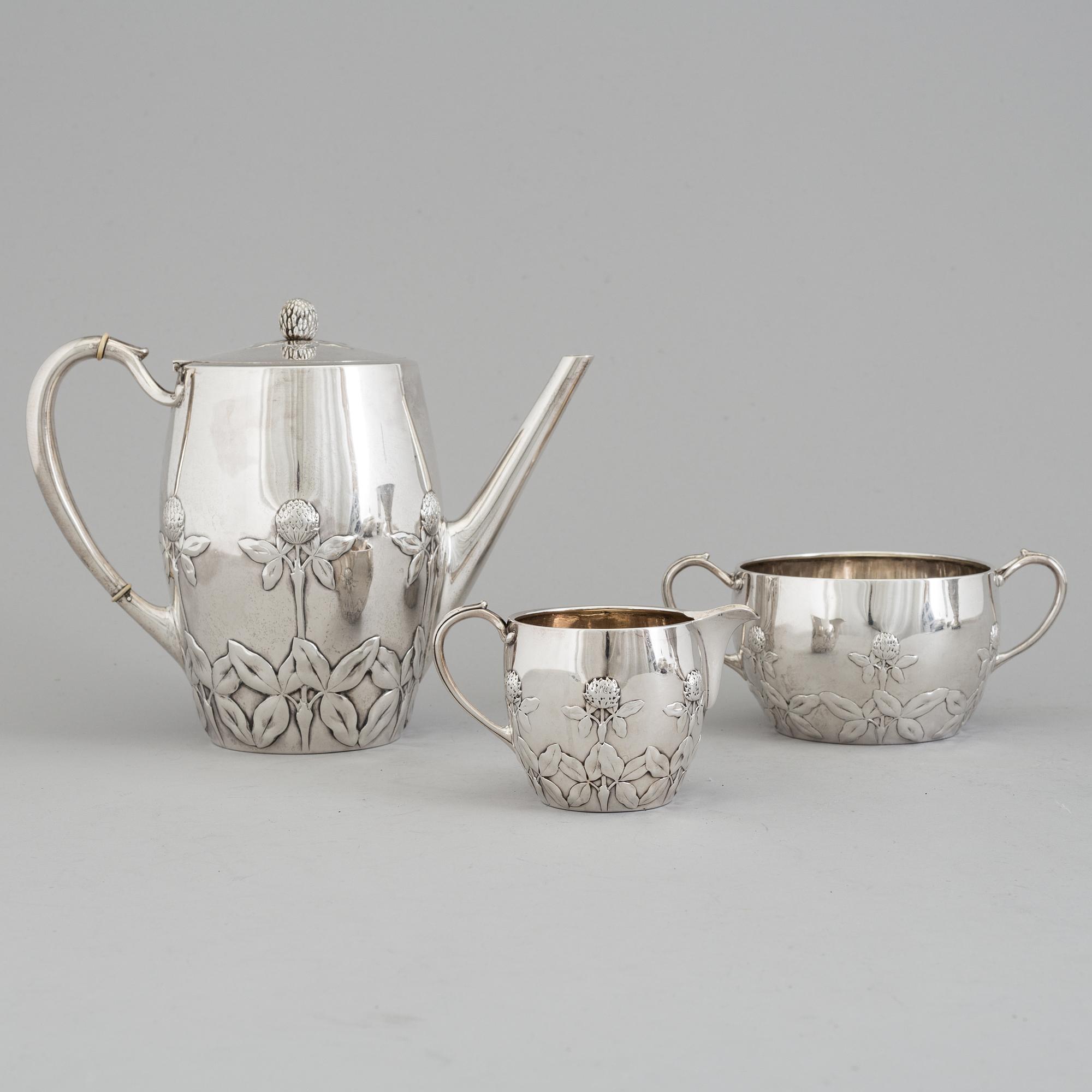 A Danish Arts and crafts sterling silver three piece coffee set, Niels Georg Henriksen for A. Michelsen, 1906 and 1921.