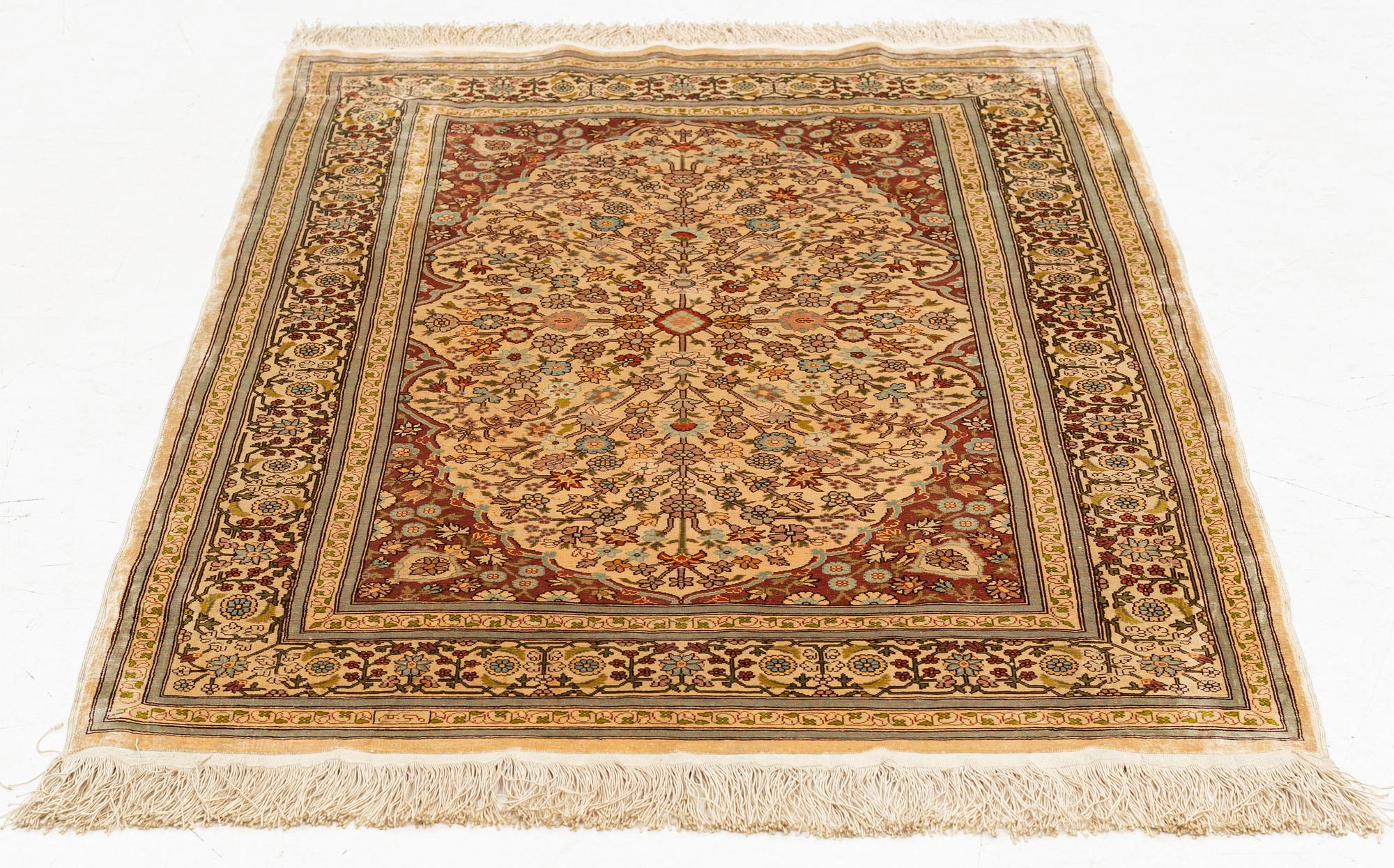 A silk Hereke rug, circa 104 x 70 cm.