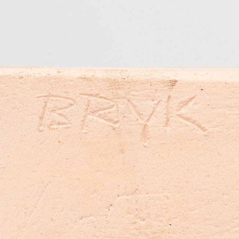 A stoneware relief signed BRYK.