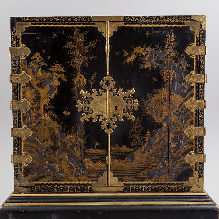 AN early 18TH CENTURY PROBABLY ENGLISH Japanned laquer cabinet on stand.