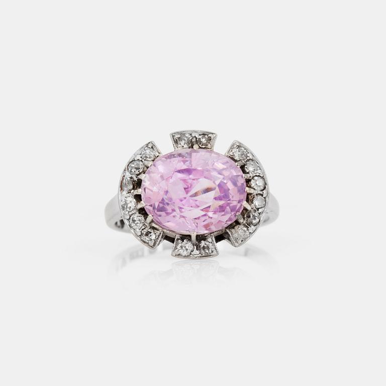 A circa 5.80 ct oval-cut pink sapphire and old-cut diamond ring. Total carat weight of diamonds circa 0.50 ct.