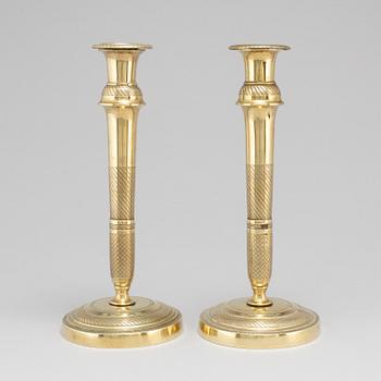 A mid 19th Century pair of brass candle sticks.