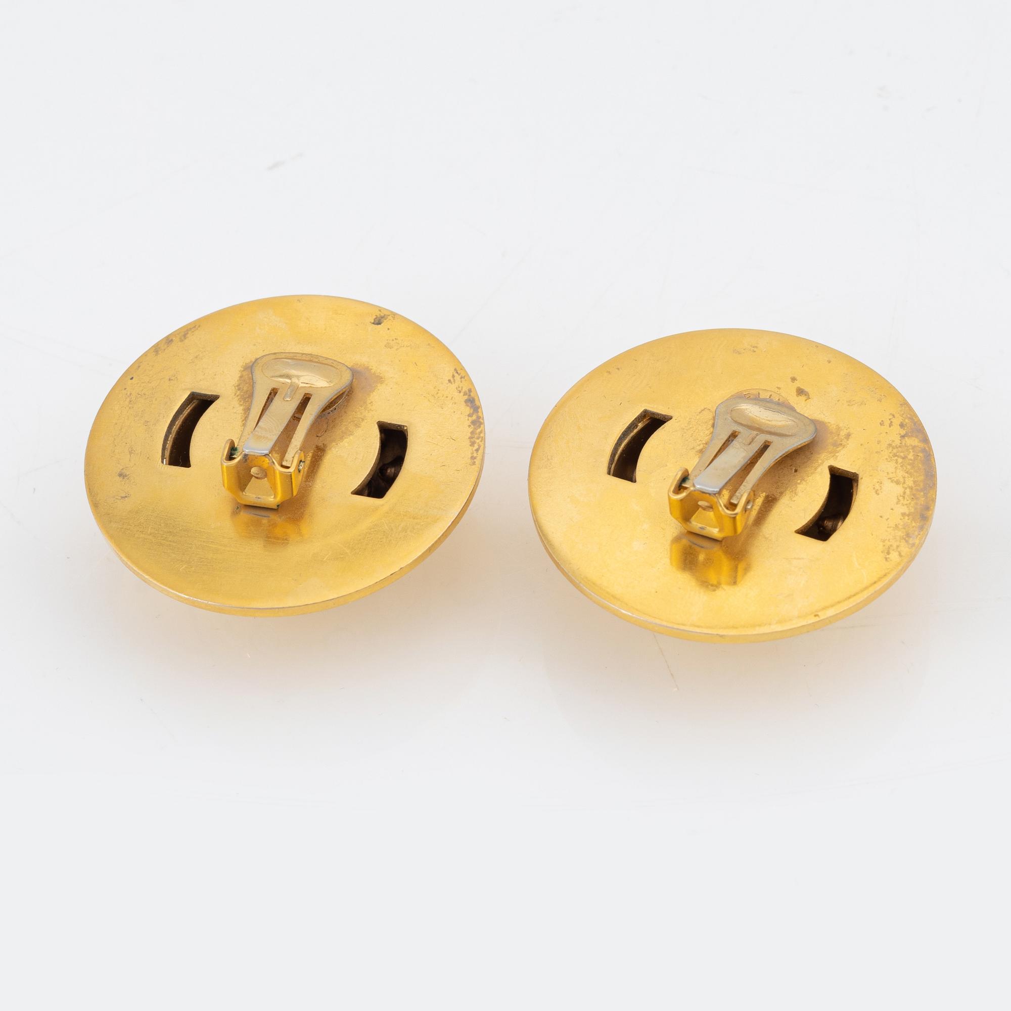 Céline, a pair of gold tone and rhinestone clip-on earrings.