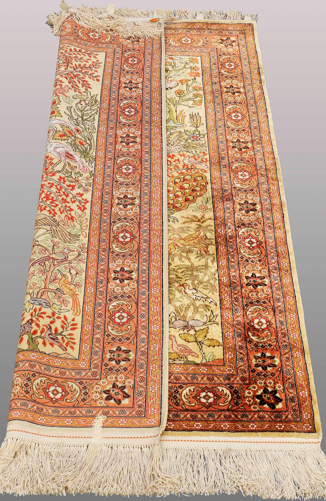 An Oriental figural silk rug, ca 126 x 83 cm.
