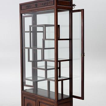 A Chinese display cabinet, wood and glass, later part of the 20th century.