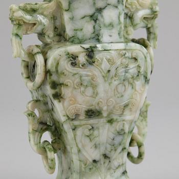 A carved green stone vase with cover, China, 20th Century.