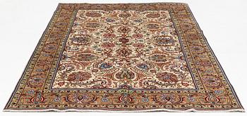 A signed Tabriz carpet, c 309 x 205 cm.