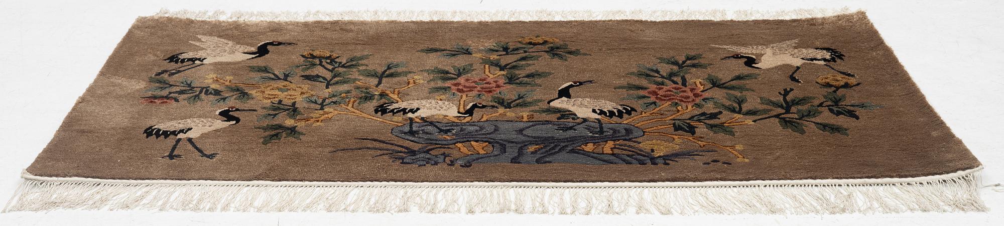 A silke figural rug, China, later part of the 20th century, ca. 92 x 170 cm.