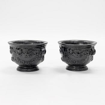 A pair of cast-iron urns.