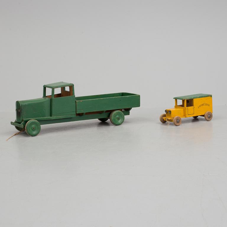 A set of two wooden toy trucks.