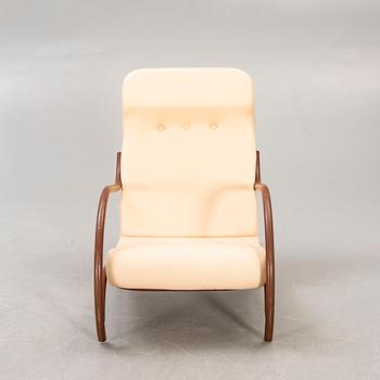 A 1930/40s metal and textile/plastic easy chair.