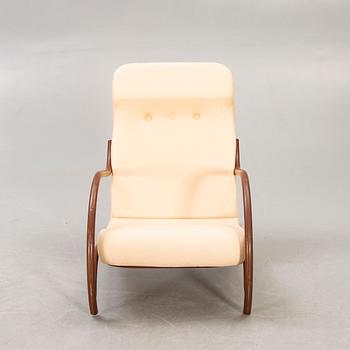 A 1930/40s metal and textile/plastic easy chair.