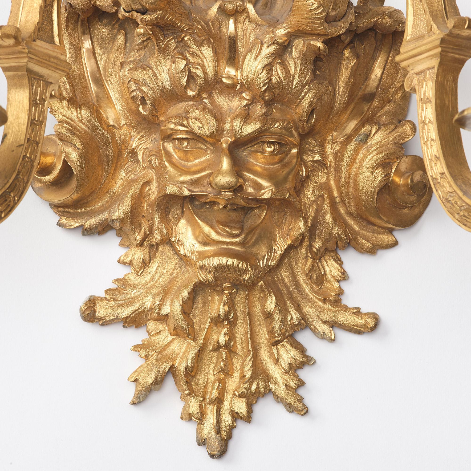 A pair of Baroque-style mid 19th century two-light wall-lights.