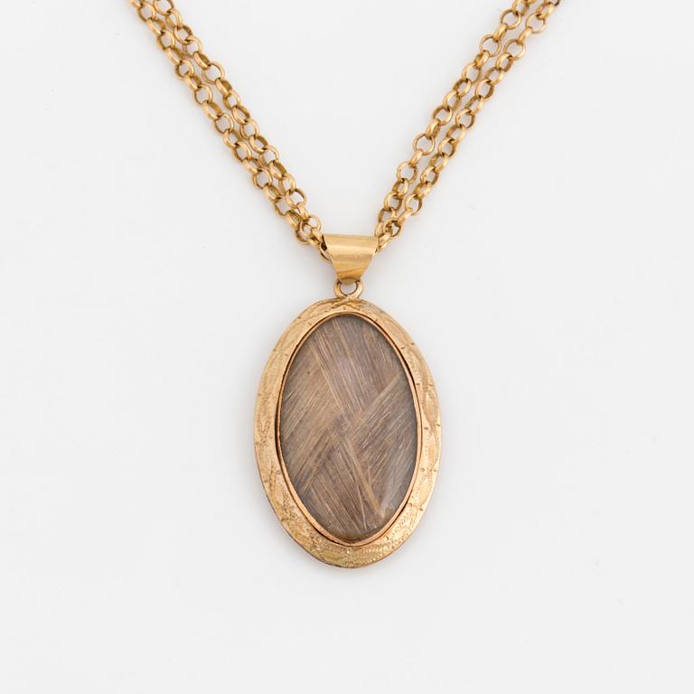 A chain and locket with hairwork.