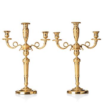 97. A pair of French Empire three-light candelabra, beginning of 19th century.