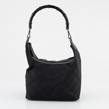 Gucci, a canvas handbag.