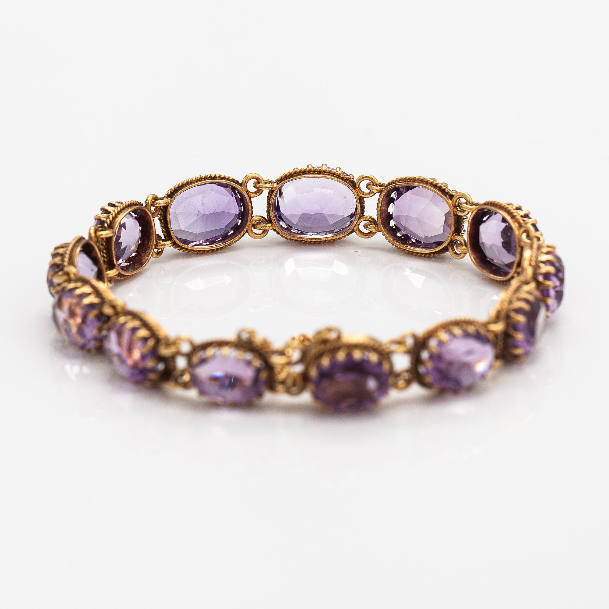 A necklace, bracelet and two brooches in gilded silver and with amethysts and pearls.