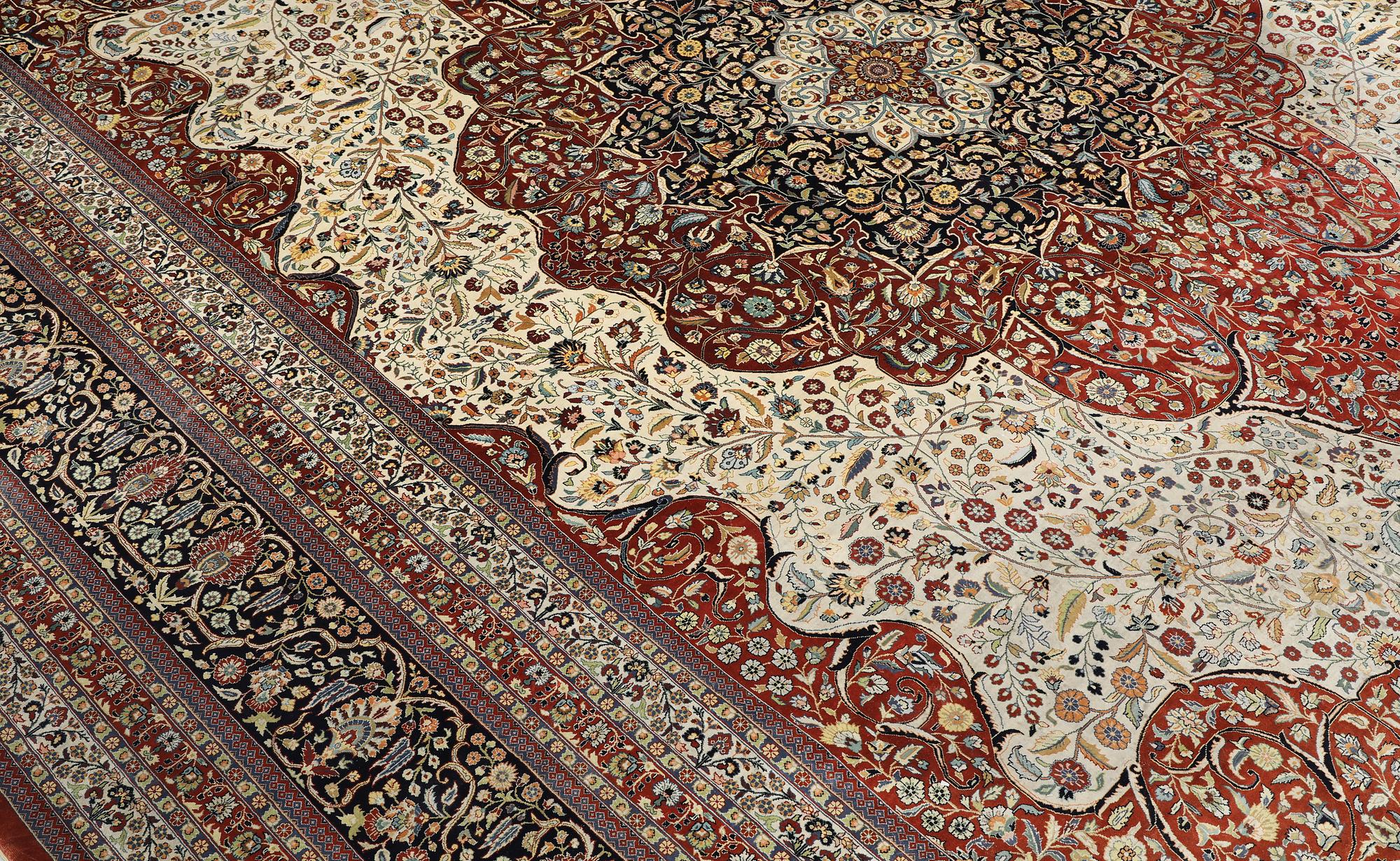 An Oriental silk carpet, c. 436 x 306 cm.