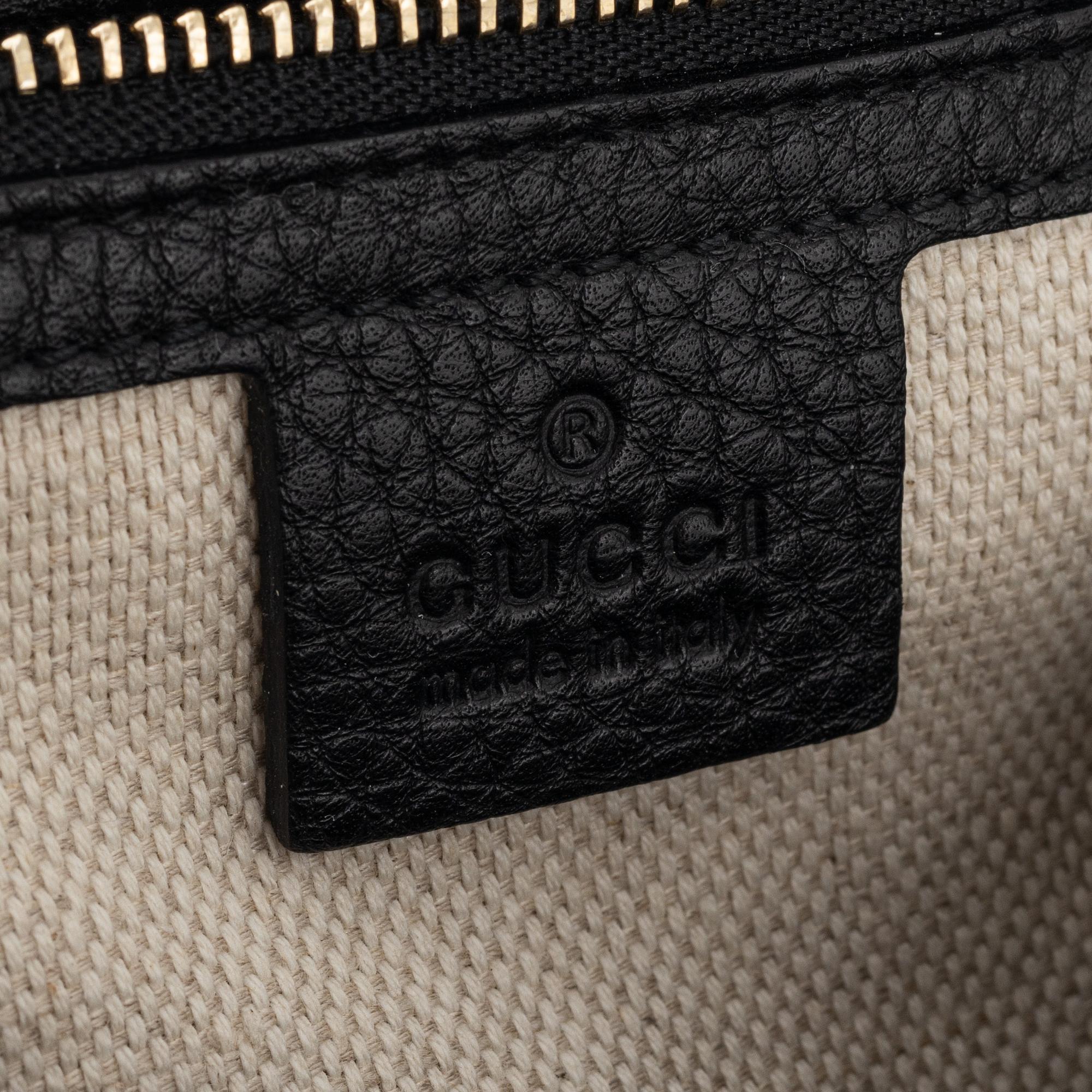 Gucci, a black leather handbag.