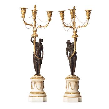 71. A pair of Louis XVI 18th century gilt and patinated bronze and marble three-light candelabra.