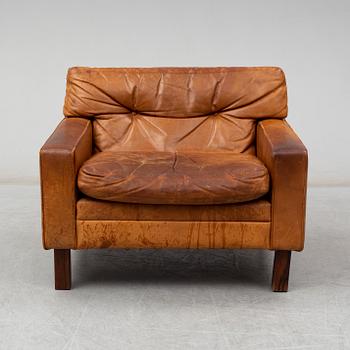 A 1960's/1970's leather covered easy chair with rosewood legs.