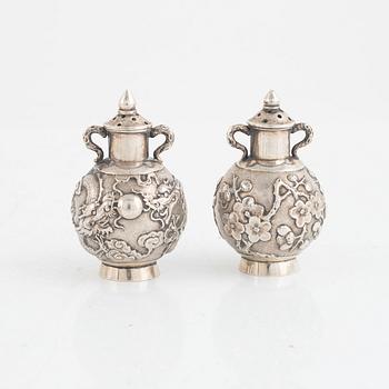 A pair of Chinese silver shakers, late Qing dynasty.