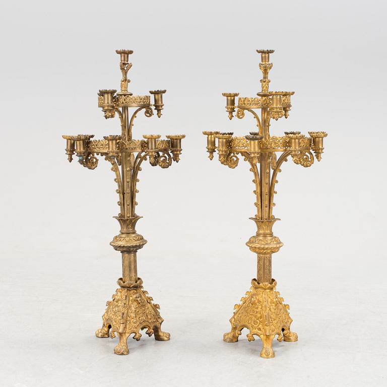 Two similar 19th century bronze candelabras.